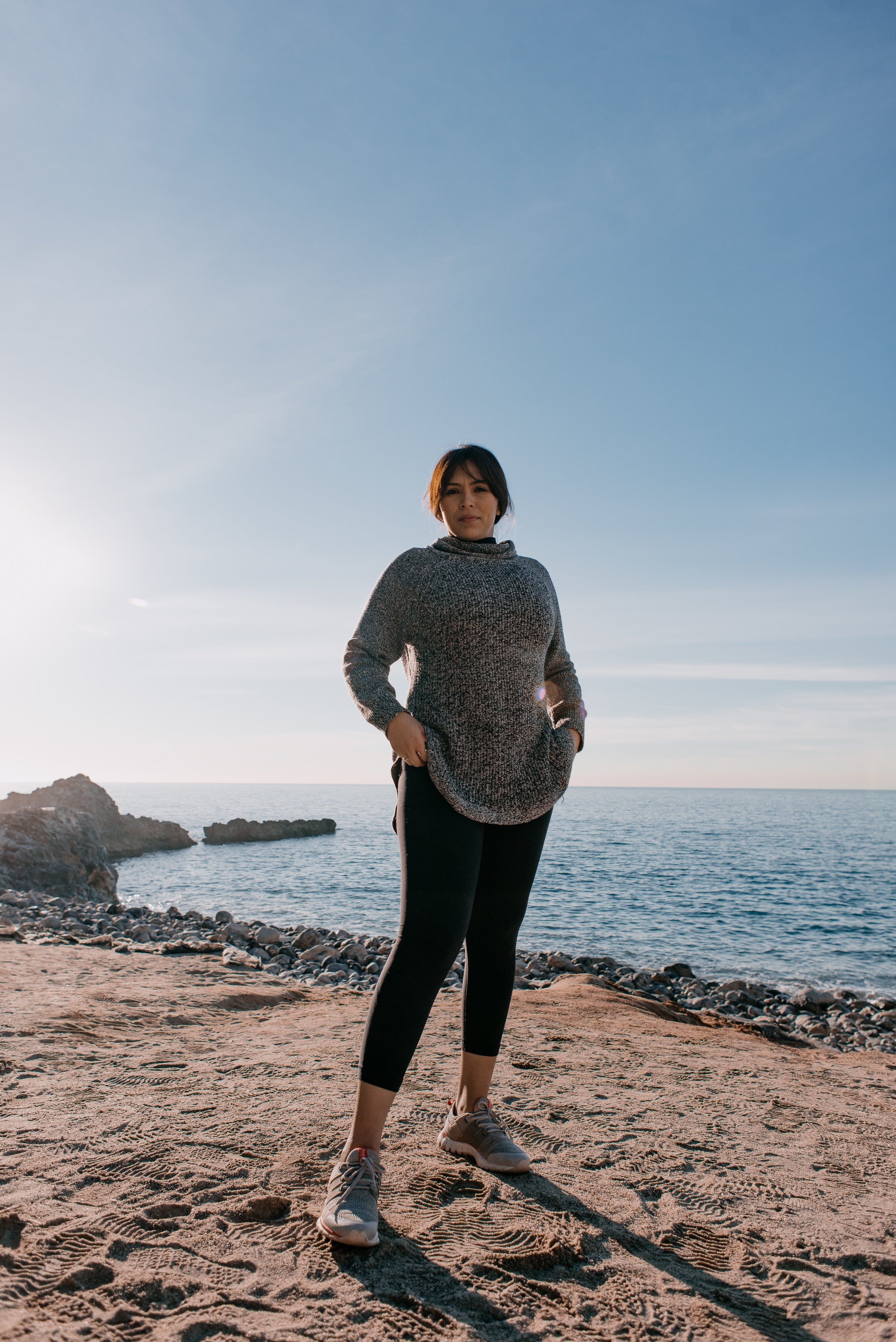 files/woman-in-sports-clothes-stands-on-a-beach-in-the-morning-light_1.jpg